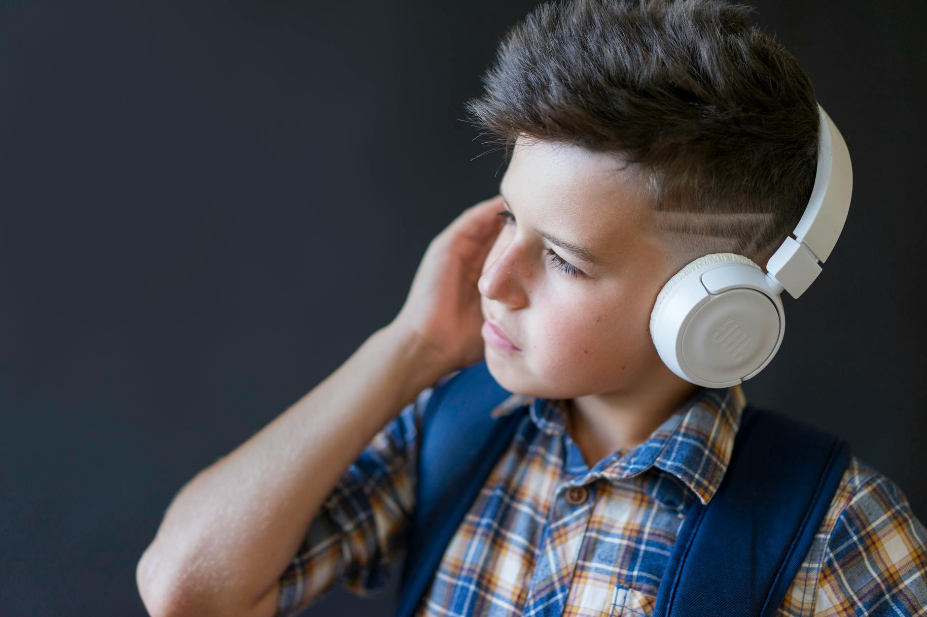 a boy wearing wireless headphones